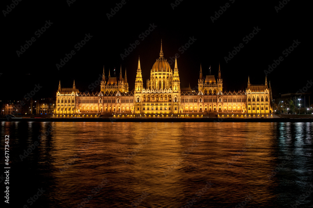 Night view from the waterfront on the Parliament of Budapest (Hungary), reflected in the river Danube. Night view from the waterfront on the Parliament of Budapest (Hungary), reflected in the river Danube.