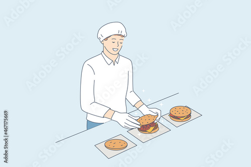 Cooking burgers and junk food cafe concept. Young smiling man chef in uniform and apron cartoon character standing and cooking cheeseburgers in restaurant kitchen vector illustration 