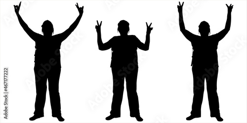 The woman shows the gesture of victory with both raised hands. Female silhouette in pants, in a cap. Three women in different positions with their hands up. Black silhouette isolated on white. Photo.