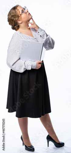 girl studio. model posing at the camera with a book. isolated white background. girl in trousers and blouse, shoes
