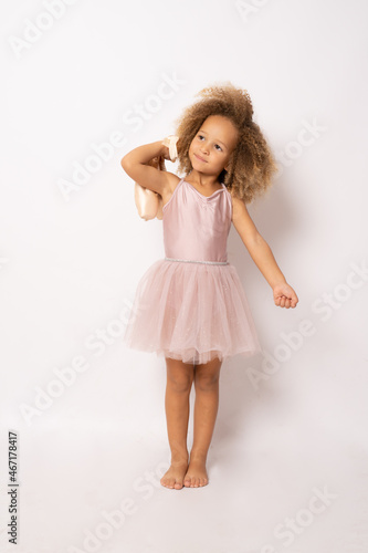 Wallpaper Mural The little ballerina getting ready for class isolated over white background. Torontodigital.ca