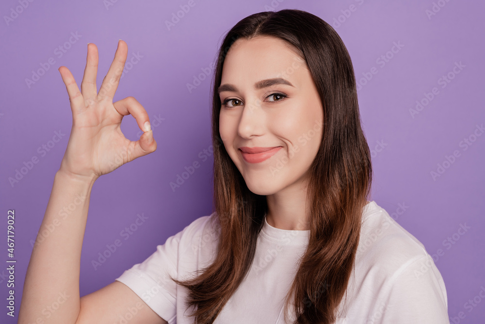 Portrait of attractive girl happy positive smile show okay alright sign isolated over violet color background Portrait of attractive girl happy positive smile show okay alright sign isolated over violet color background