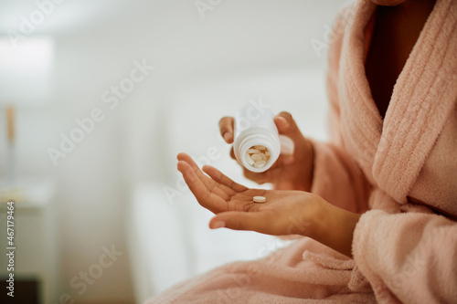 Photos Close-up of woman takes a medicine at home.