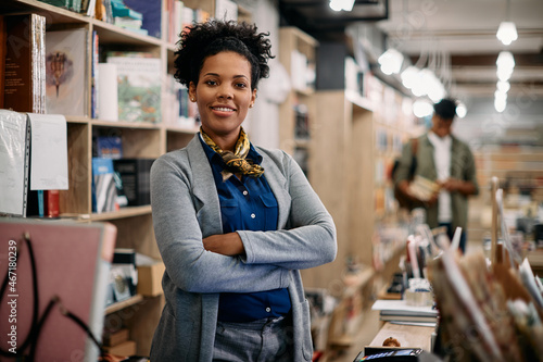 Portrait of confident African American bookstore owner looks at camera. photo