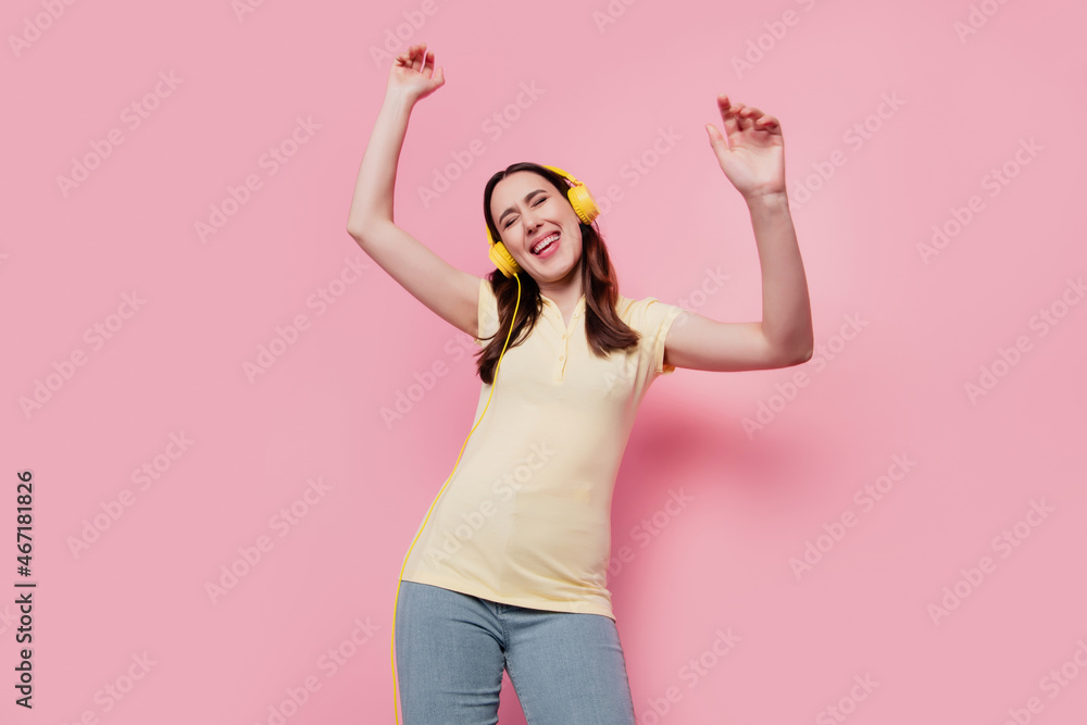 Photo of funny carefree disco party clubber lady dance wear headphones listen music on pink background Photo of funny carefree disco party clubber lady dance wear headphones listen music on pink background