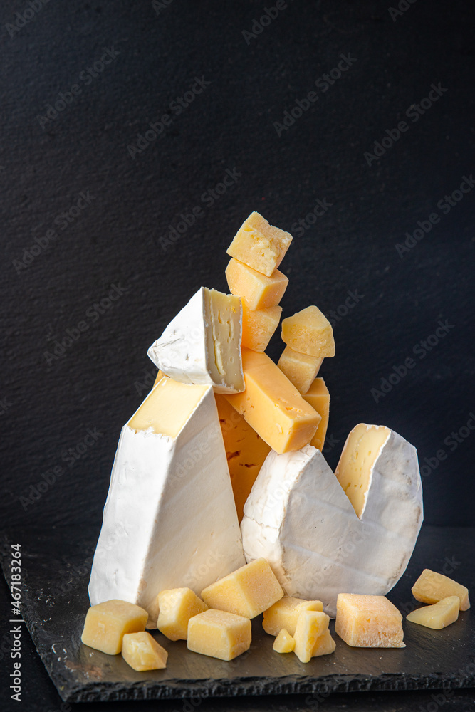 Fototapeta premium cheese plate assorted cheeses aperitif antipasto brie, camembert, cheddar, parmesan and others ready to eat meal snack on the table copy space food background rustic. top view