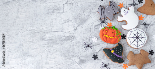 Banner with delicious and tasty halloween cookies on white textured concrete. creepy cookies in the shape of a pumpkin, a black cat, a bat for the autumn holiday.