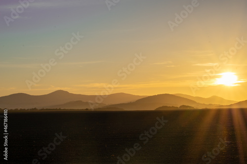 sunset over Zittau Mountains with colourful sky shot against the sun