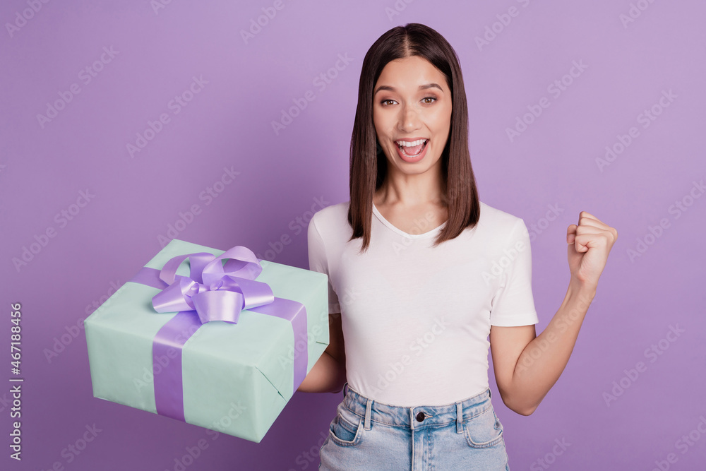 Portrait of pretty funky cheerful girl rejoice victory lucky success holding in hands giftbox isolated over vivid violet color background