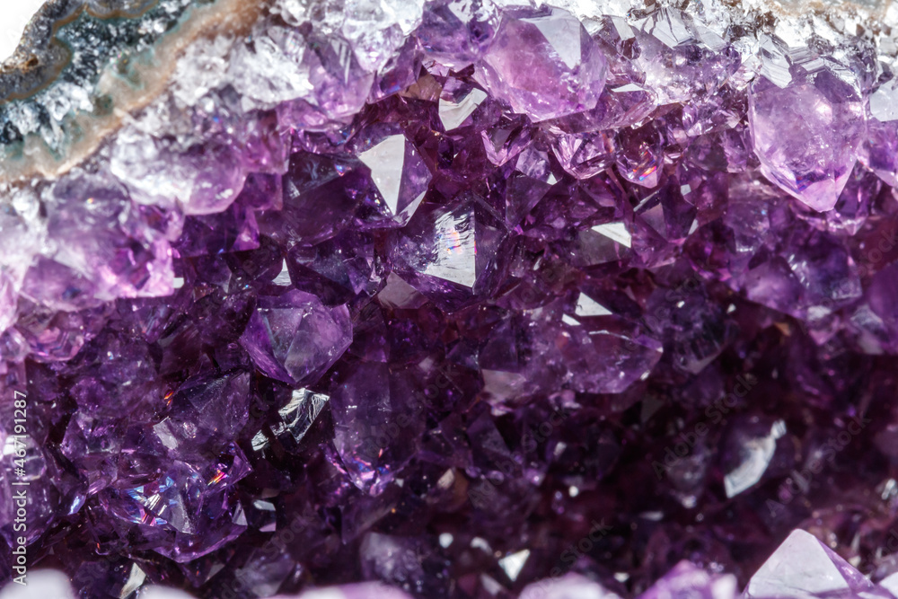 Fototapeta premium Macro Mineral Stone Amethysts in the rock on a white background