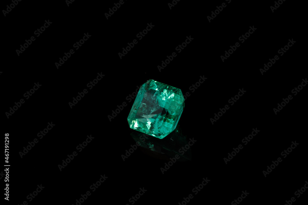 Macro mineral Emerald gemstone faceted on black background Macro mineral Emerald gemstone faceted on black background