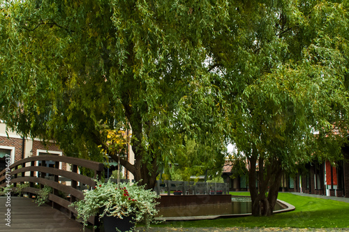 Garden in the park, bridge over the canal