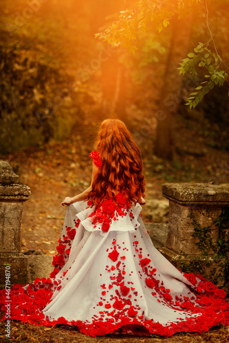 Beautiful girl with red hair in autumn park