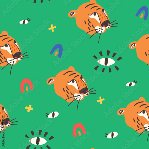 Seamless pattern tiger face eyes on green background. Wild Cat predator orange and black vector modern flat style background