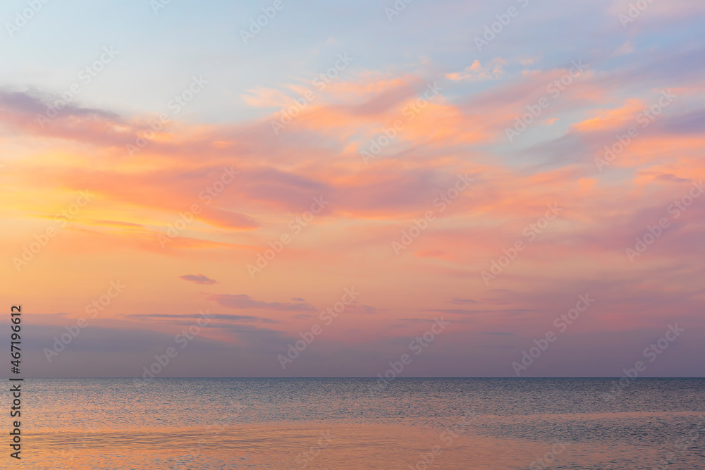 Colored clouds over the sea at sunset