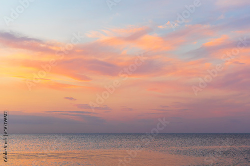 Colored clouds over the sea at sunset © alexmu