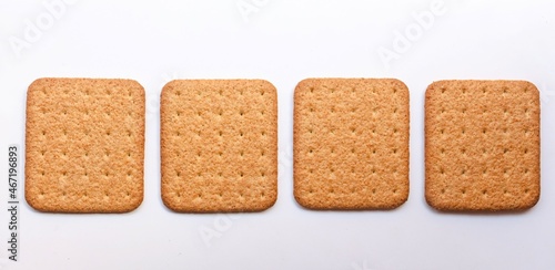 four square shaped biscuit on white background, top view, selective focus