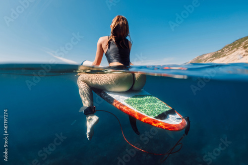 Sexy surf girl on surfboard in ocean, split view photo