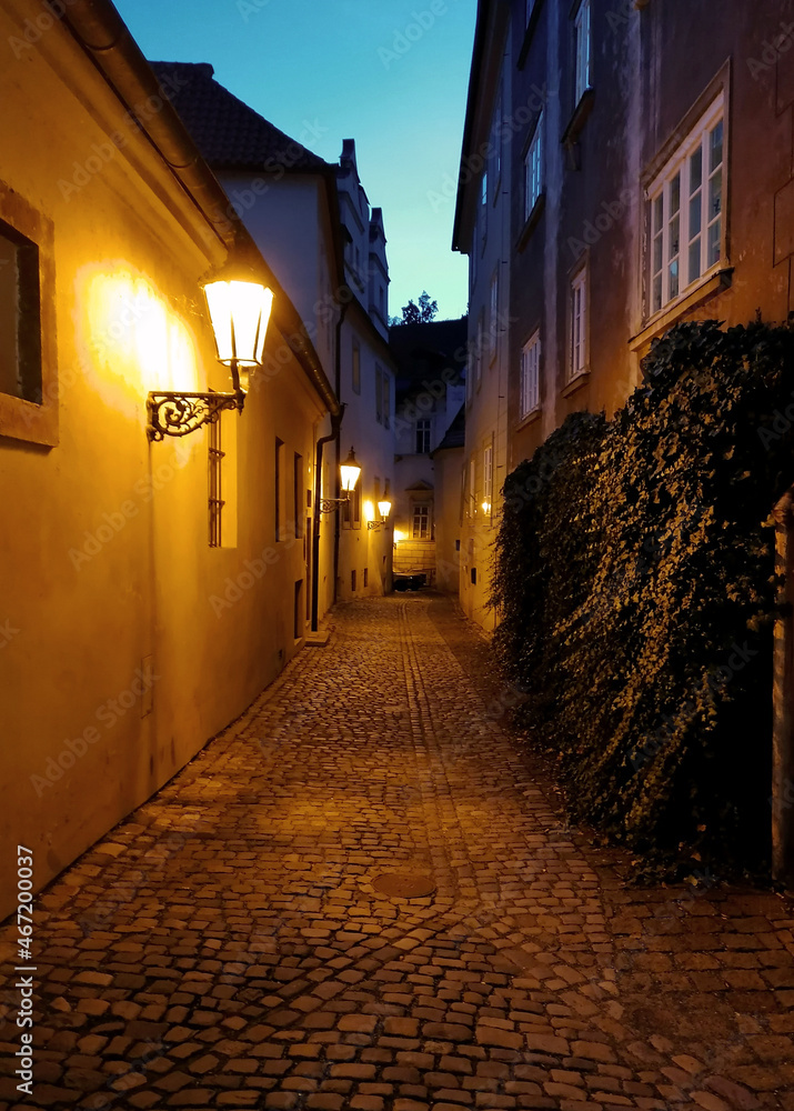 Old Prague night street with street lamps stock images. Ancient architecture in night Prague city. Czechia old town photo. Mysterious Prague stock images