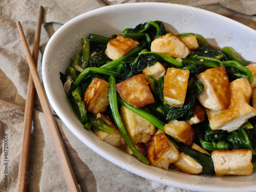 Obraz na plátně Dish made of fried tofu with boiled pak choi served in oval bowl