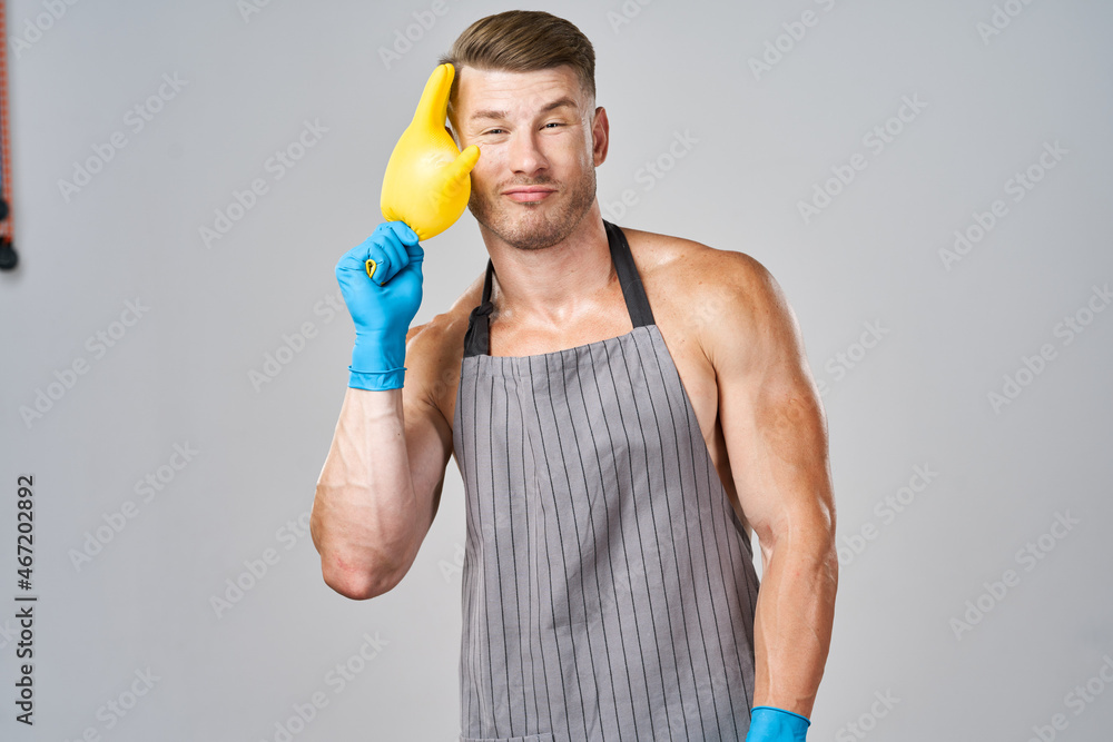 pumped up man in apron rubber gloves cleaning housework pumped up man in apron rubber gloves cleaning housework