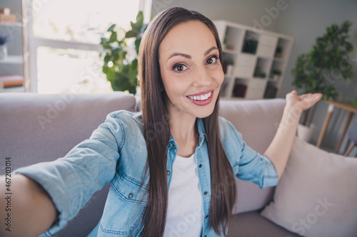 Self-portrait of attractive cheerful long-haired woman demonstrating flat welcome rest staying at home indoors