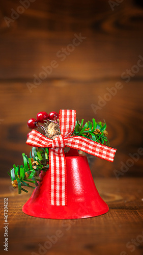 Christmas bells on brown wooden background with copy space