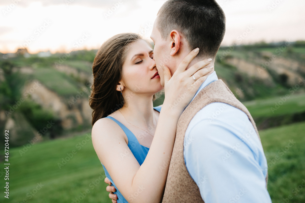 young couple a guy and a girl are walking in the mountain hills young couple a guy and a girl are walking in the mountain hills