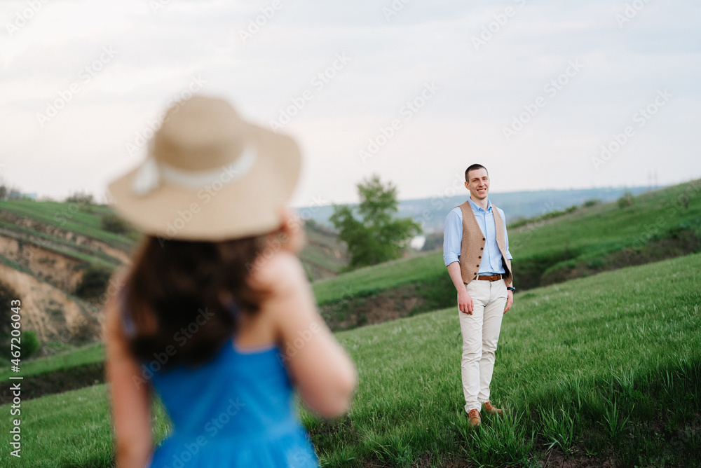 young couple a guy and a girl are walking in the mountain hills
