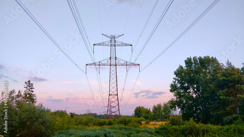 Electrical power grid pole seeing from the bottom up to the gray cloudy sky. It seems there is going to be rain soon.