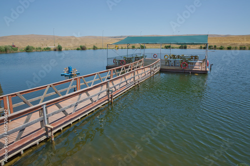 Landscape of an mountain lake in front of mountain range. Glorious lake landscape. The collaboration of blue and green. Restaurant and bridge in the middle of the lake . View of Abant Lake Golu .