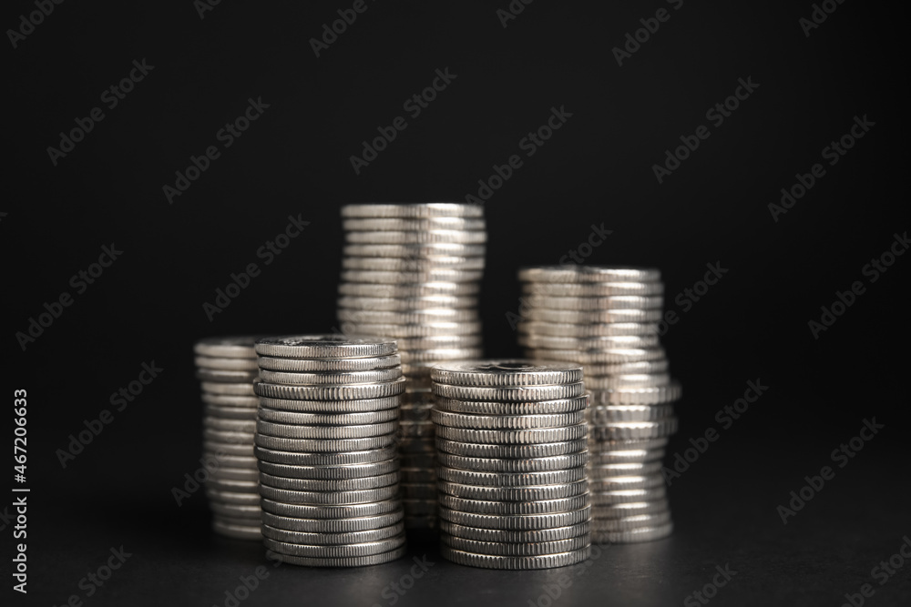 Many Euro coins stacked on black background Many Euro coins stacked on black background