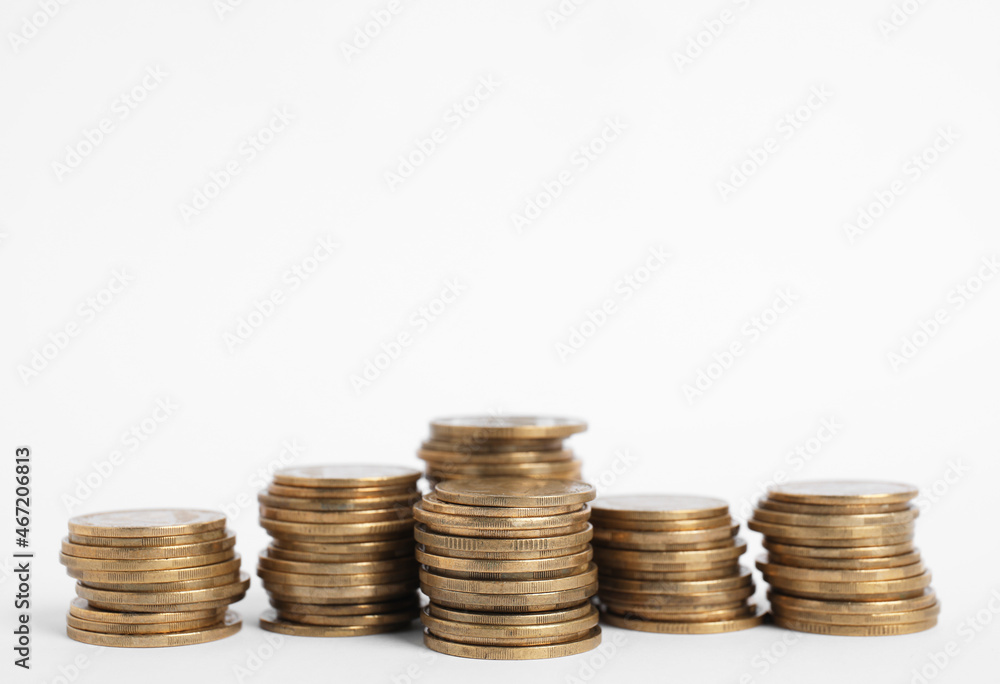 Many Euro coins stacked on white background Many Euro coins stacked on white background