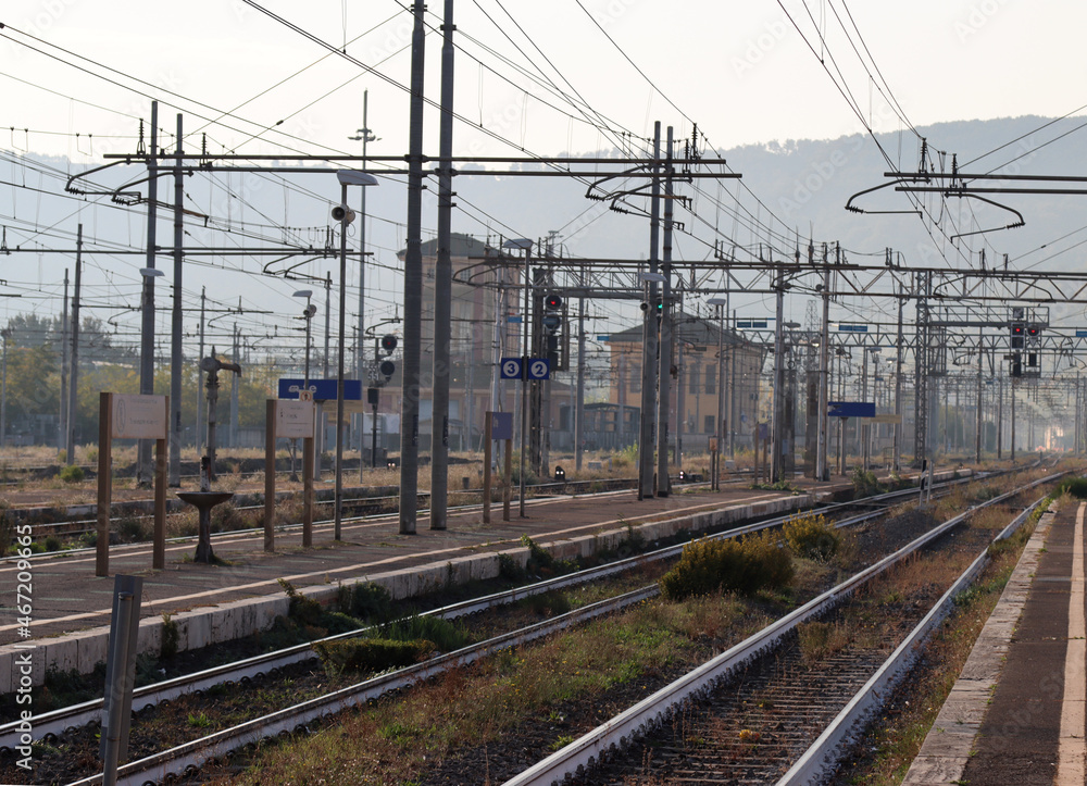 railway station of an Italian city with travelers travelers