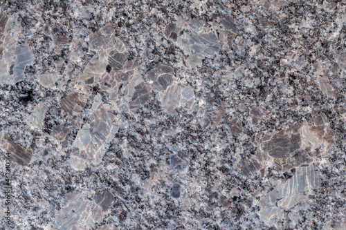 Closeup of phaneritic granite. Coarse-grained intrusive igneous rock. Polished granite slab for background photo