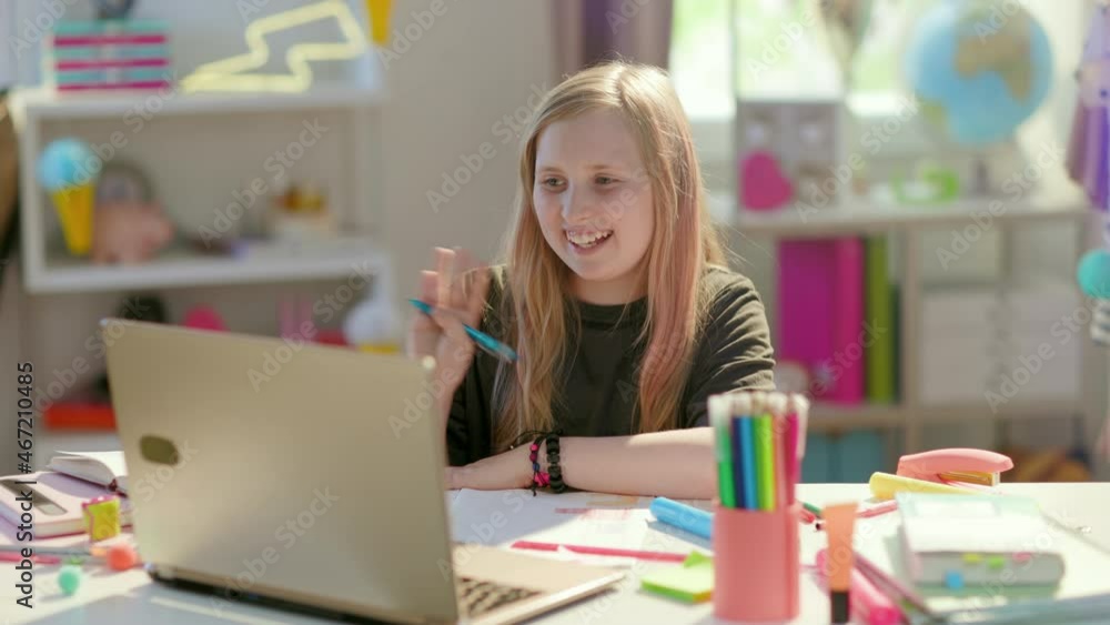 tired modern girl in grey shirt with laptop, headphones and workbook homeschooling and stretching at home in sunny day.