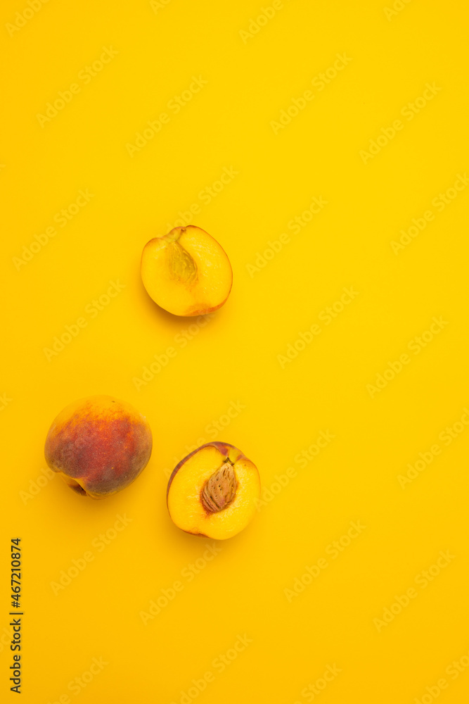 Flat lay composition with fresh peaches on yellow background. Flat lay top view copy space.