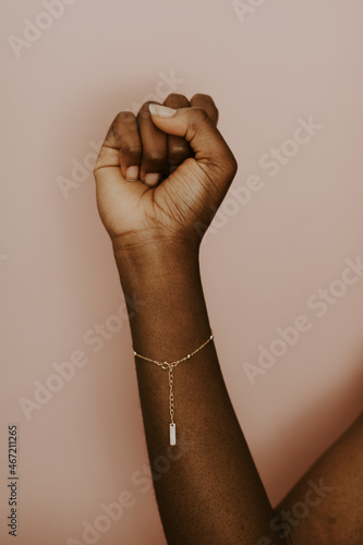 Black woman wearing a gold bracelet photo