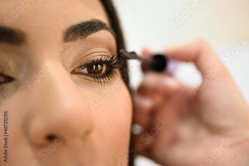 Close-up shot of woman wearing mascara photo