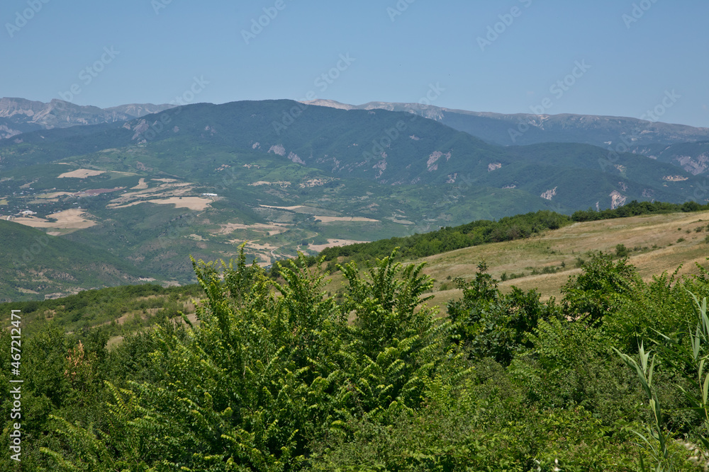 Green mountains covered with forest on the blue sky background. Panorama .Mountain green valley landscape. Beautiful mountain green valley panorama. Green mountains and mountain tops .