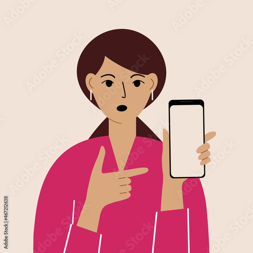 Angry woman with mobile phone, front view. Indicates the phone. News. Smartphone and internet addiction.