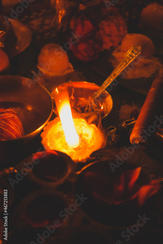 Lit diyas beside saffron flowers on a table photo