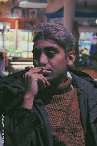 Man with gray hair smoking indoor photo