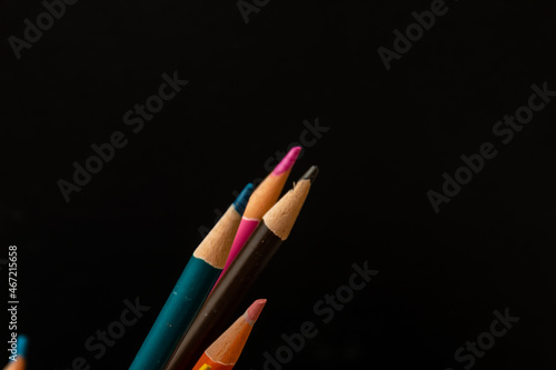 Multi colored coloring pencils on  dark background