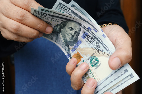 Person counting dollars