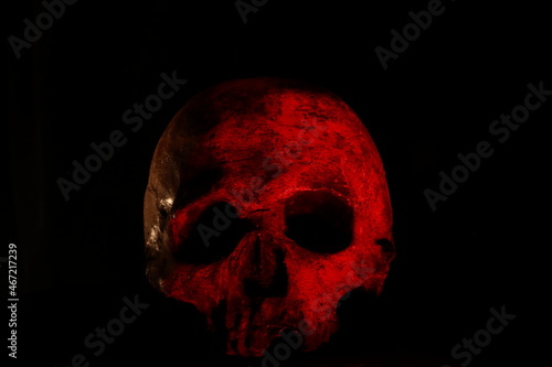 Red skull against dark background photo