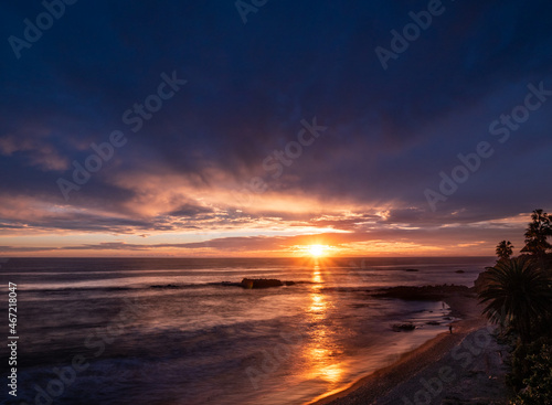 Sunset in cloudy sky over the ocean photo