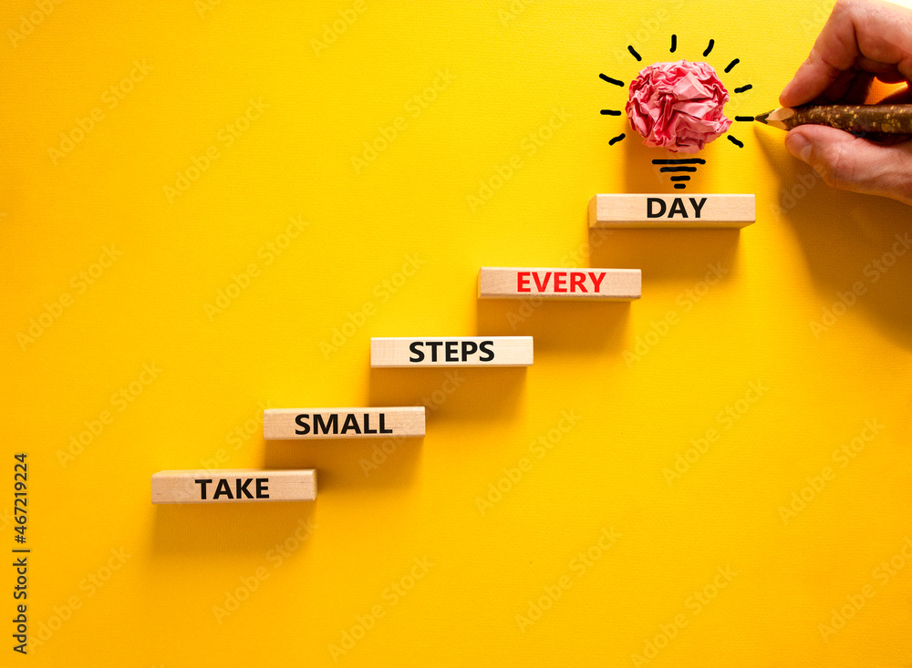Take small steps every day symbol. Wooden blocks with words Take small ...