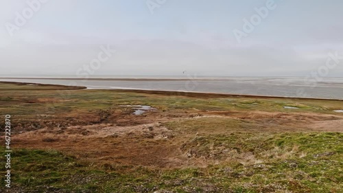 Panoramic view of landswell of Yamal peninsula and Kara sea. Flock of geese flying in the sky over water. photo