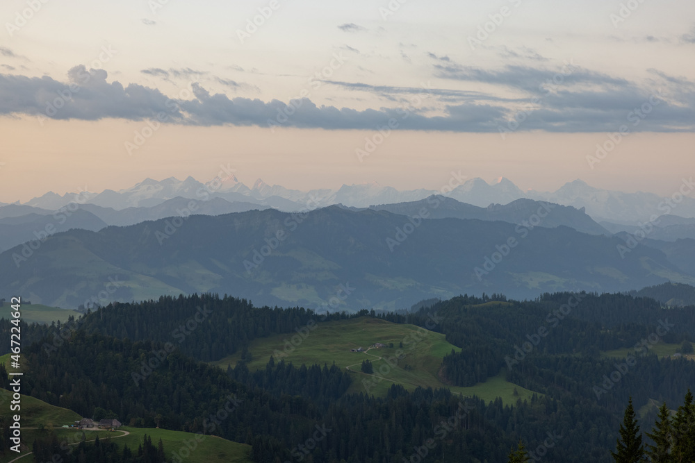 Amazing sunset at a wonderful landscape in Switzerland on a hill called Napf. Wonderful morning view with the alps in the horizon. Amazing sunset at a wonderful landscape in Switzerland on a hill called Napf. Wonderful morning view with the alps in the horizon.